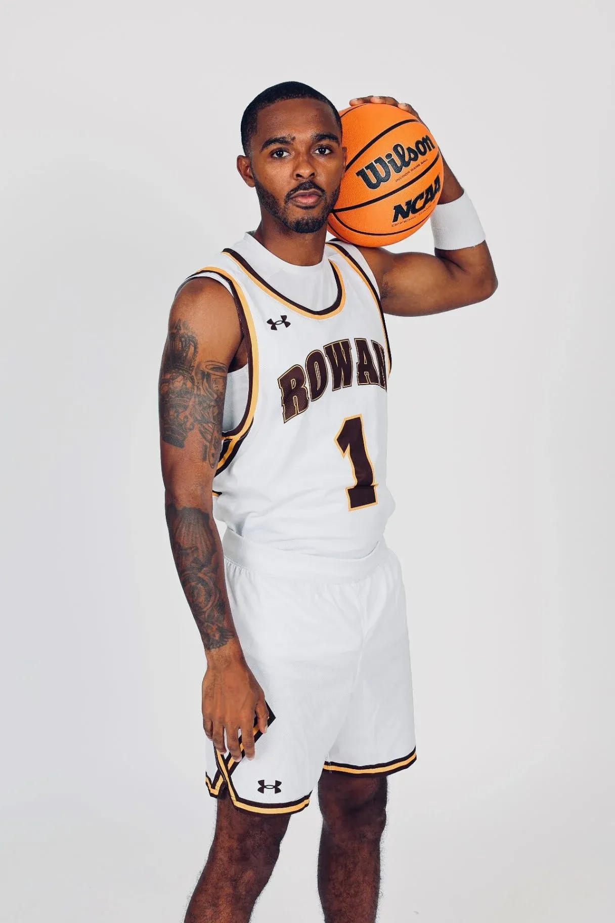Fareed Burton Jr. in a Rowan College uniform holding a basketball